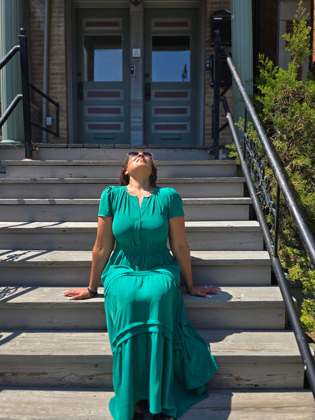 sitting on stoop looking up feeling the warmth of the sun